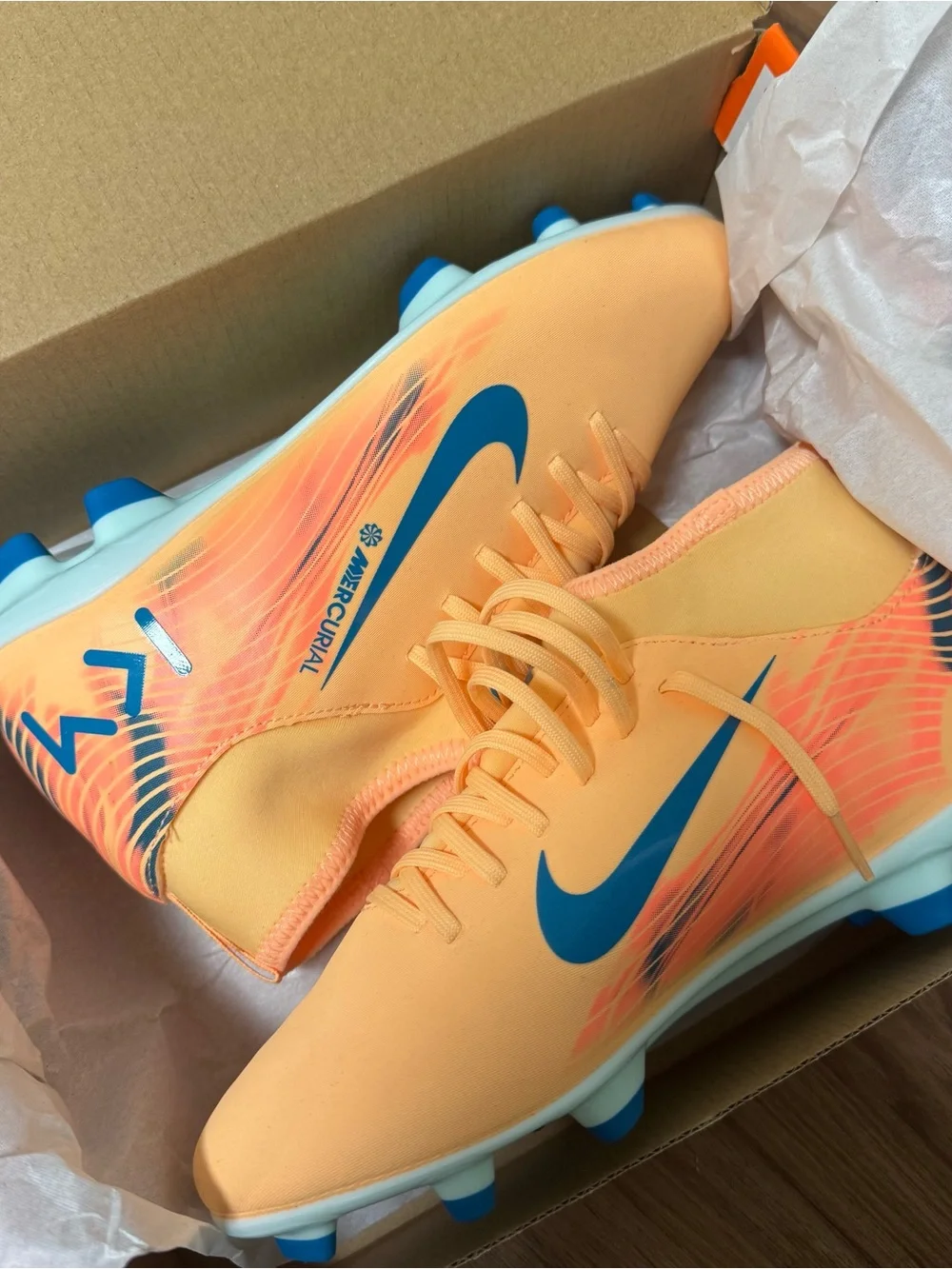 Nike Kids Orange Soccer Cleats with Blue Swoosh